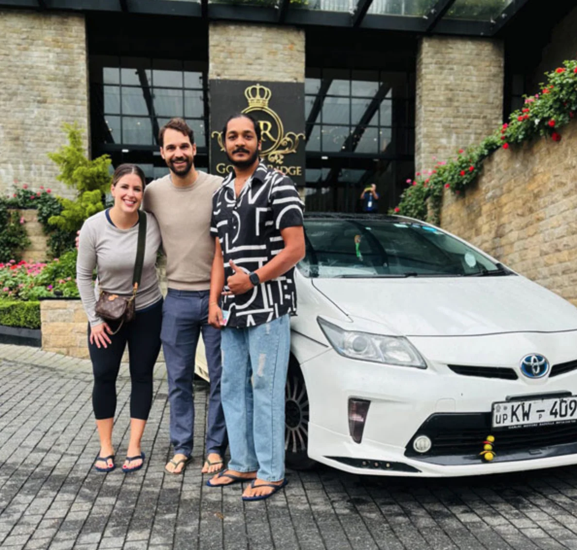 International couple beside their private car and driver in Sri Lanka