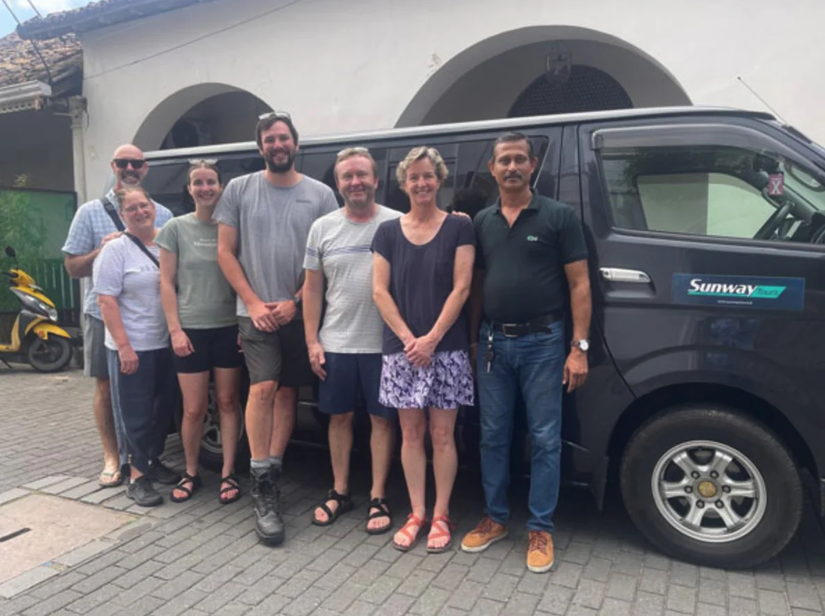 Group of travellers beside a passenger van in Sri Lanka