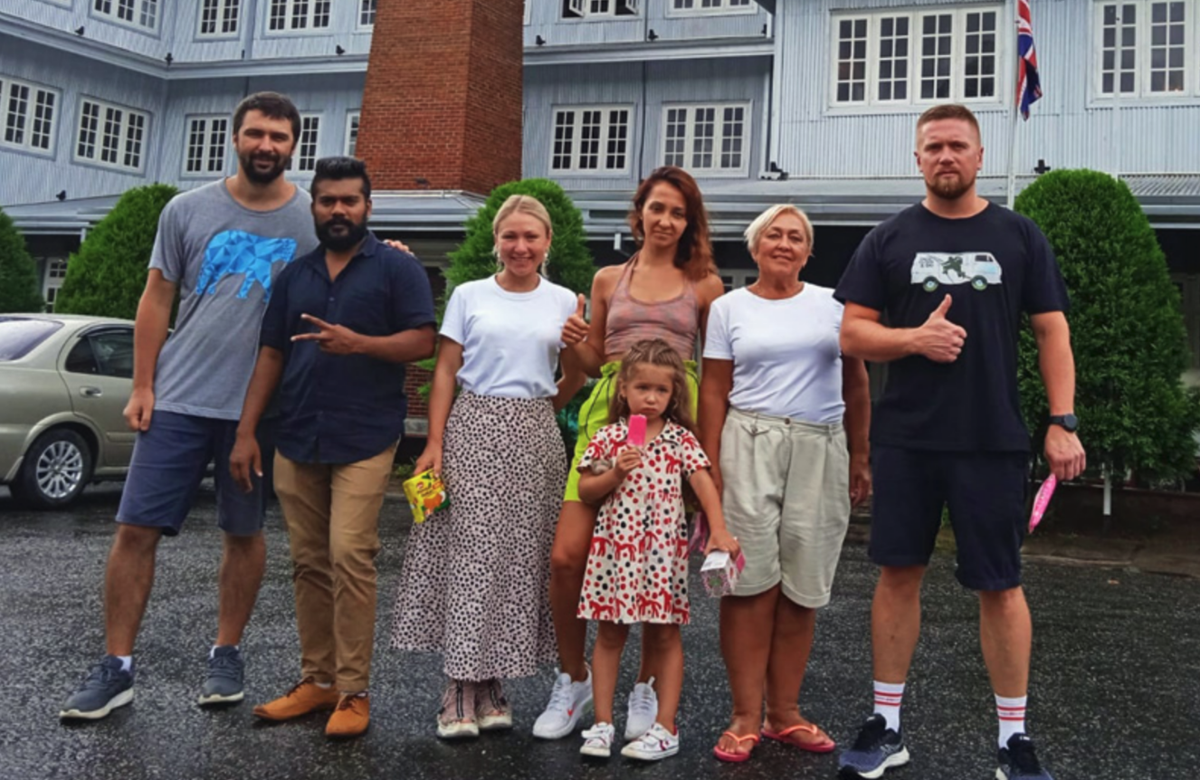 International travelers with their Sri Lankan driver at a hotel during a private road trip